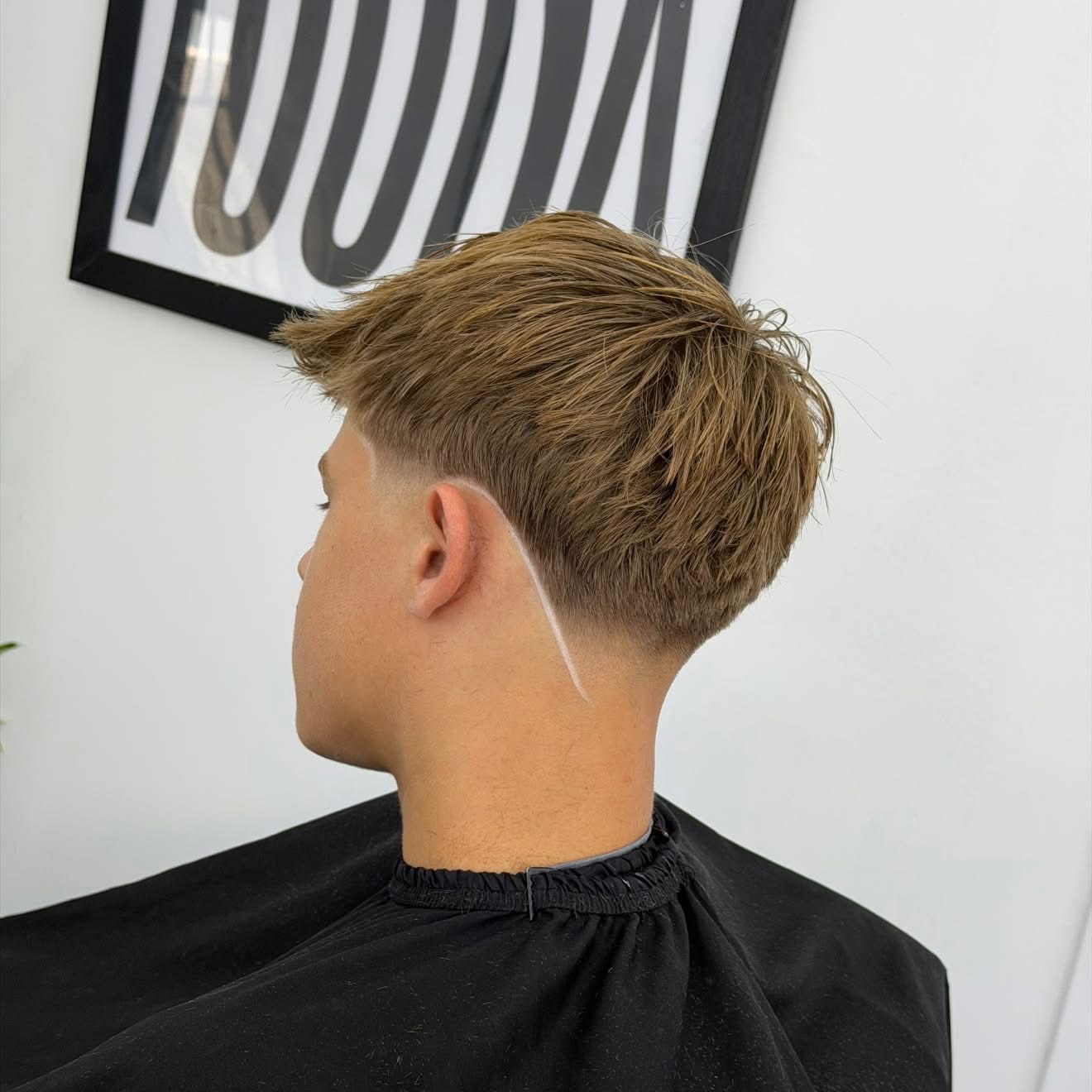 Textured haircut with a shaved line
